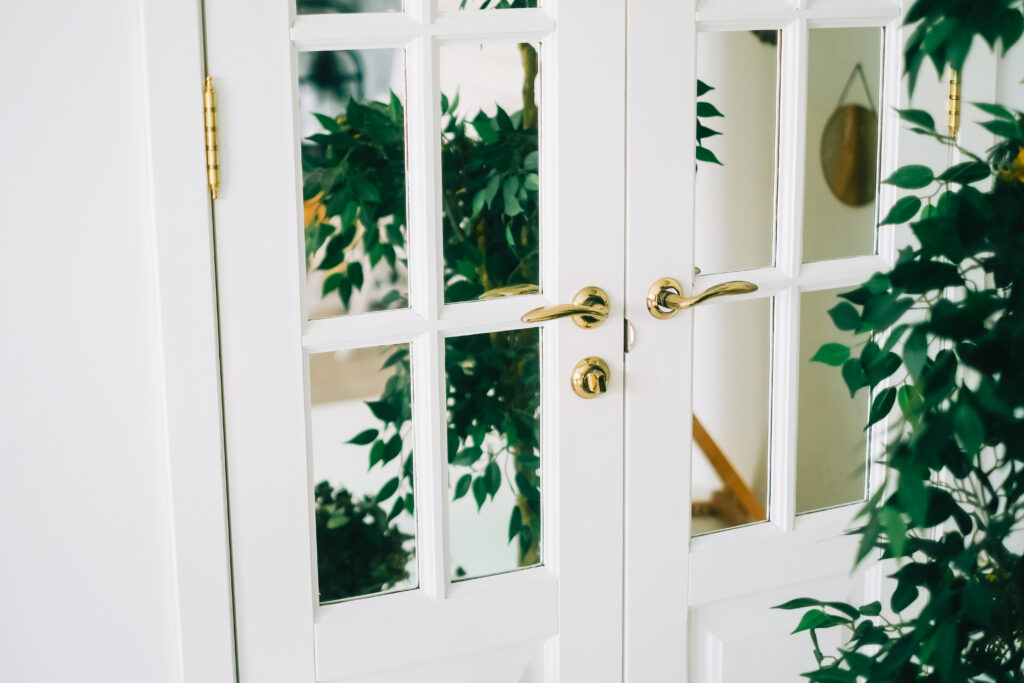 Wooden doors with mirror glass in a home garden.